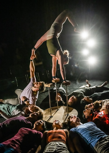 Photo Credit: Maike Schulz<br /><br />Ashleigh Pearce (center) balances above the audience as company member Jacob Randell (left) assists her from below.