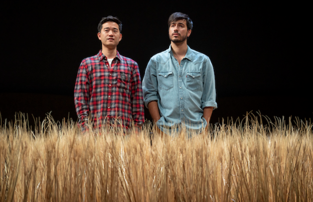 Two men standing in a field of tall grass

Description automatically generated with medium confidence