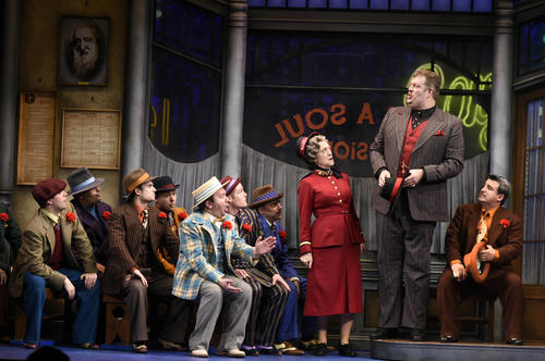 Big Jule, played by Jerry Gallagher, testifies at a prayer meeting as the crapshooters and General Matilda B. Cartwright, played by Karen Murphy, listen.