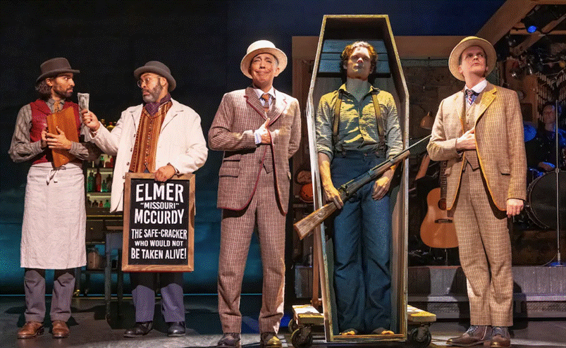 A group of men standing on a stage
Description automatically generated