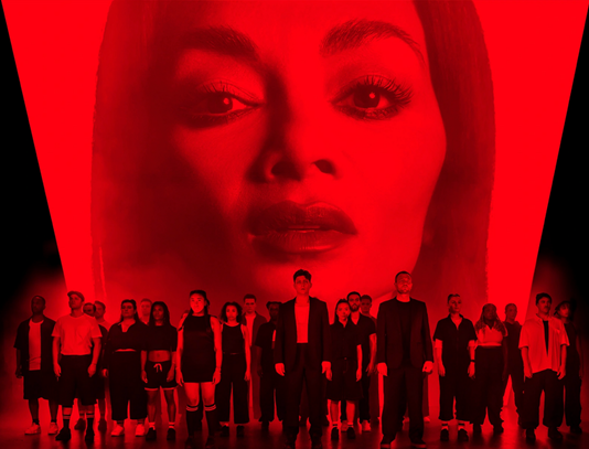 A group of people standing in front of a red background

Description automatically generated