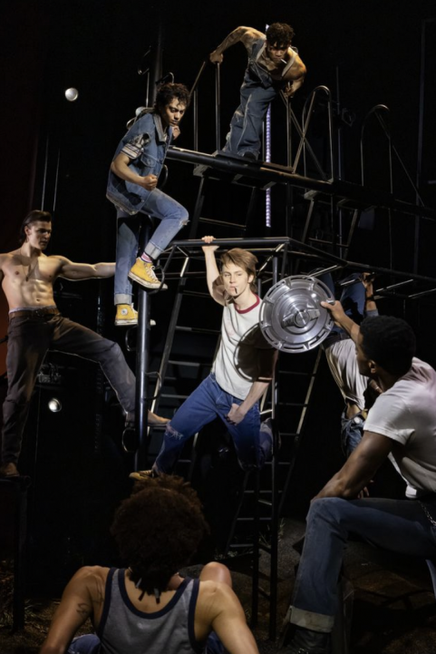 A group of men on stage Description automatically generated