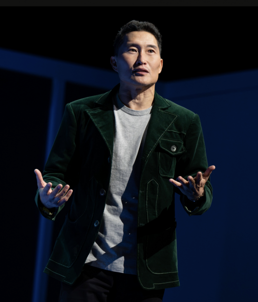 A person in a green jacket

Description automatically generated