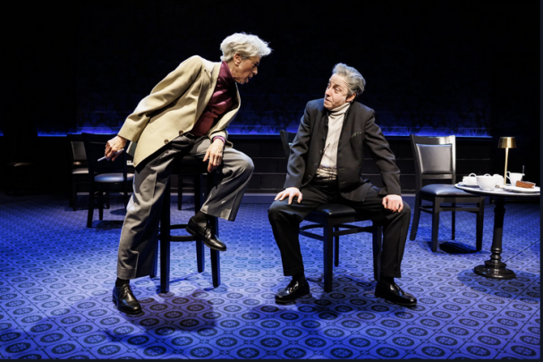 A person and person sitting on chairs

Description automatically generated