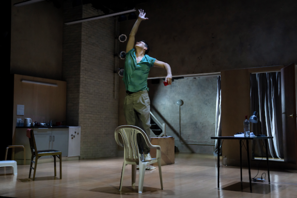 A person standing on a chair Description automatically generated