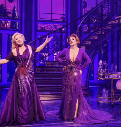 A group of women in purple dresses on a stage

Description automatically generated