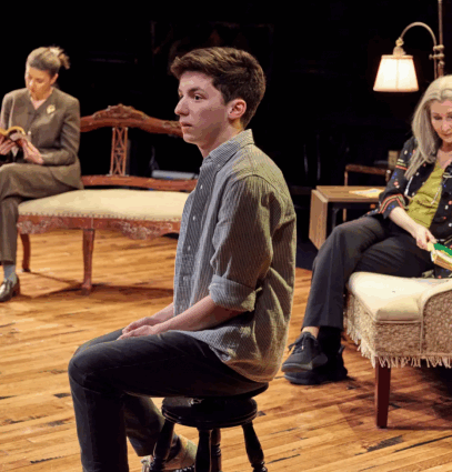 A group of people sitting on a stage

Description automatically generated