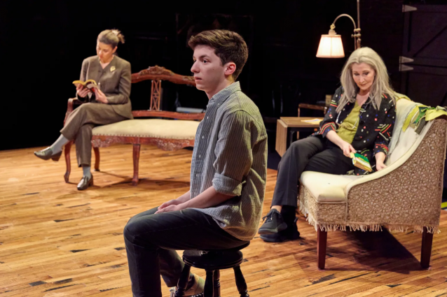 A group of people sitting on a stage

Description automatically generated