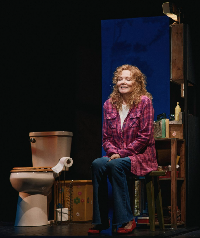 A person sitting on a toilet Description automatically generated