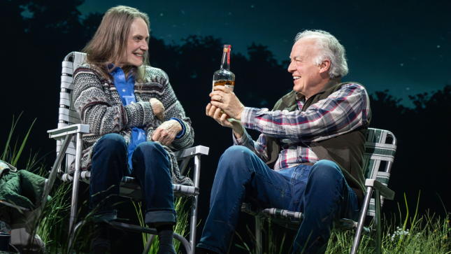 A person and person sitting in chairs holding a bottle of alcohol

Description automatically generated