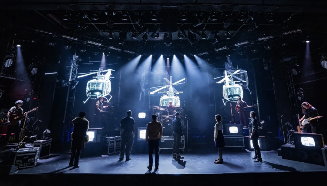 A group of people on a stage Description automatically generated