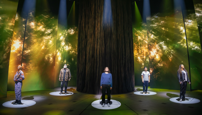 A group of people standing on a stage

Description automatically generated
