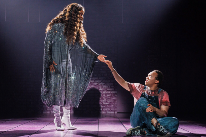 A person kneeling down and a person in a dress Description automatically generated