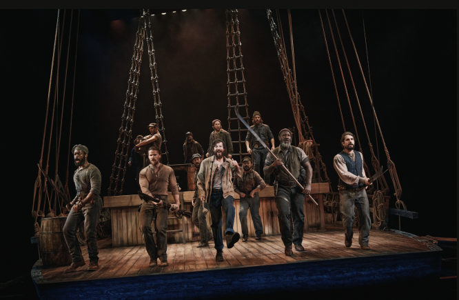 A group of men on a stage

Description automatically generated