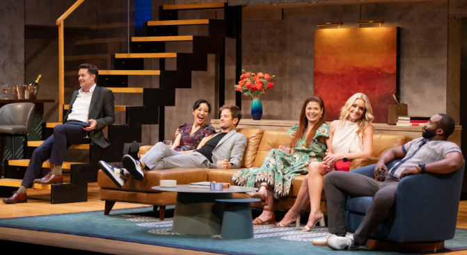 A group of people sitting on a couch
Description automatically generated