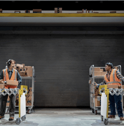 A couple of workers in a warehouse

Description automatically generated