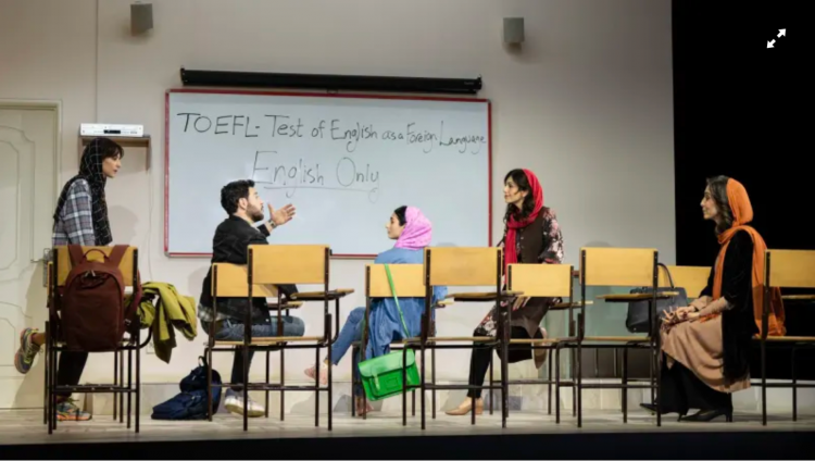 A group of people sitting in chairs in a classroom
Description automatically generated