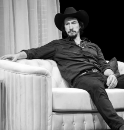 A person in a cowboy hat sitting on a couch

Description automatically generated