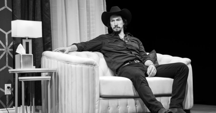 A person in a cowboy hat sitting on a couch
Description automatically generated