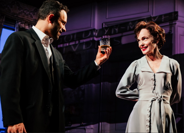 A person holding a glass of alcohol
Description automatically generated