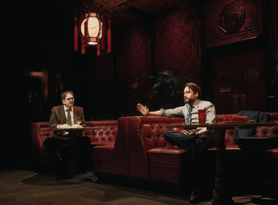 A group of men sitting at a table in a restaurant

Description automatically generated