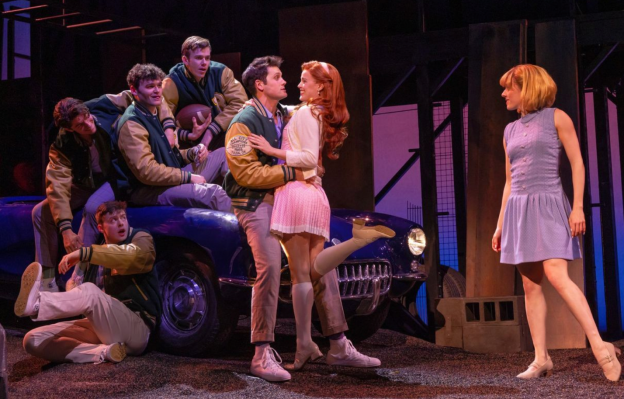 A group of people on a stage Description automatically generated