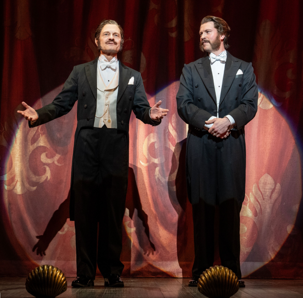 Two men in tuxedos on a stage

Description automatically generated