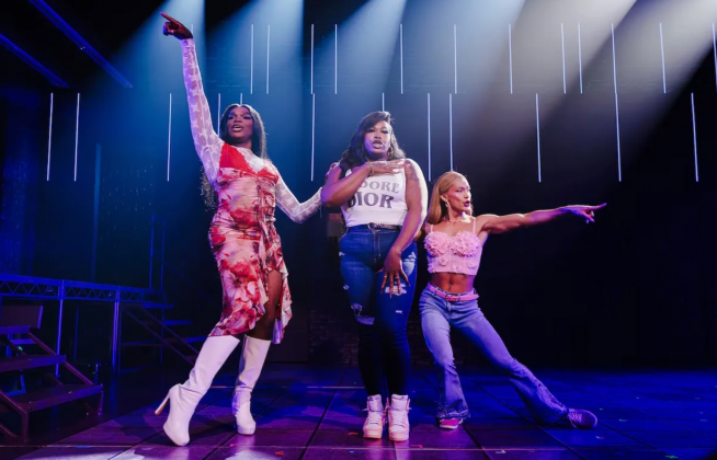 A group of women dancing on a stage Description automatically generated