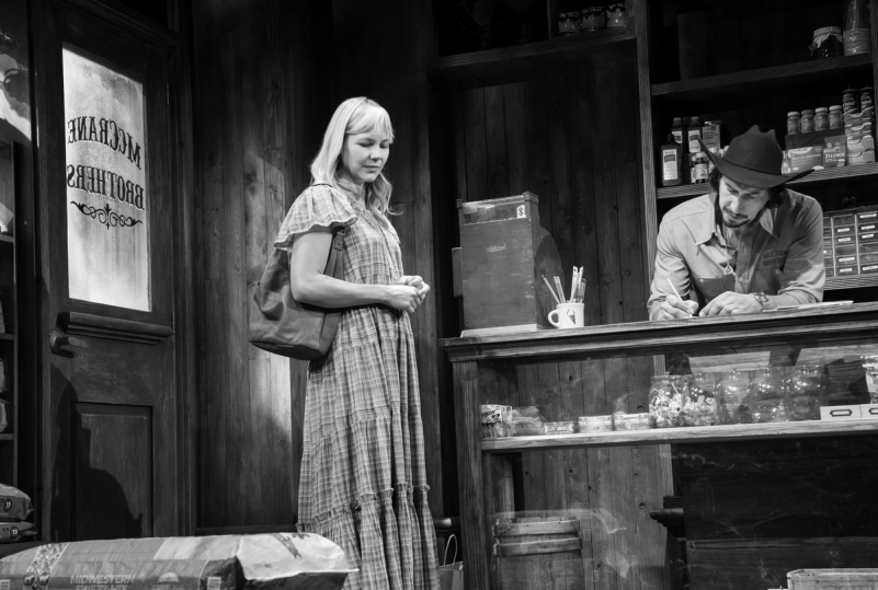 A person standing in front of a person behind a counter
Description automatically generated