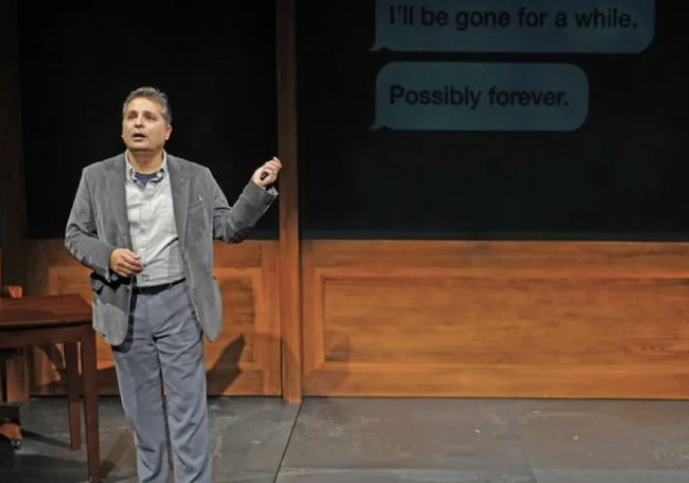 A person standing on a stage Description automatically generated