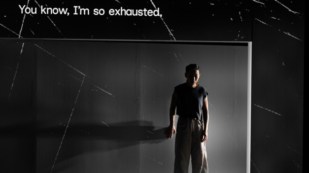 A person standing in front of a screen

Description automatically generated