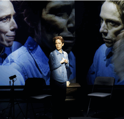 A person standing in front of a large screen

Description automatically generated