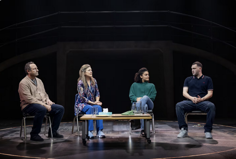 A group of people sitting on a stage Description automatically generated