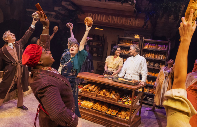 A group of people in a bakery Description automatically generated