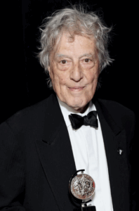 A person in a tuxedo and bow tie

Description automatically generated