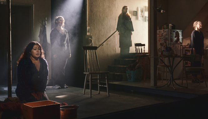 A group of people standing on a stage

Description automatically generated