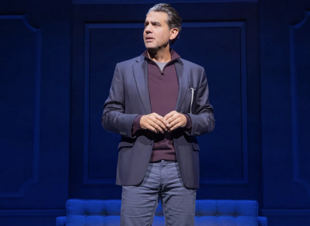 A person standing on a stage

Description automatically generated