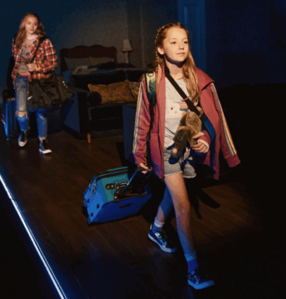 A group of girls walking with luggage

Description automatically generated