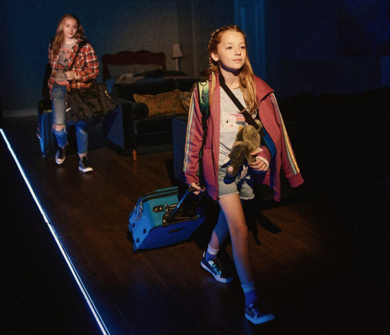 A group of girls walking with luggage

Description automatically generated