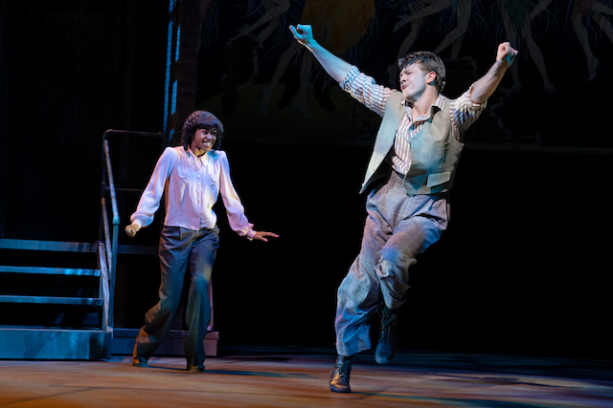 A person and person dancing on stage
Description automatically generated