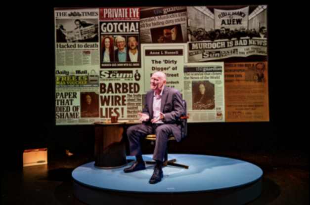 A person sitting on a stage Description automatically generated