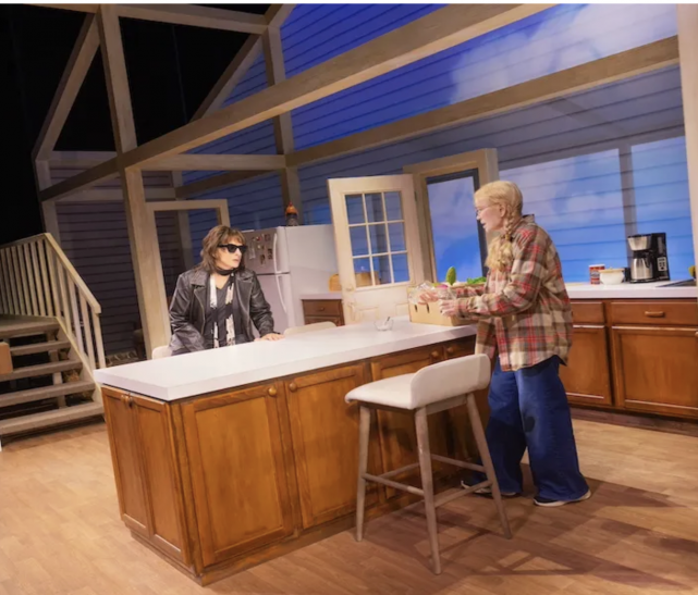 A person standing next to a person in a kitchen
Description automatically generated