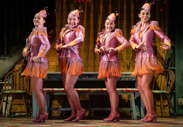 A group of women in pink clothing
Description automatically generated