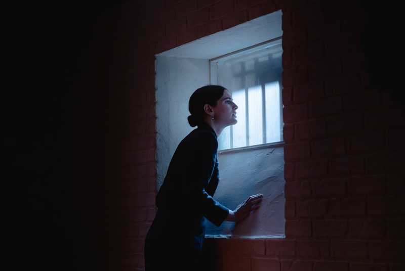 A person looking out a window