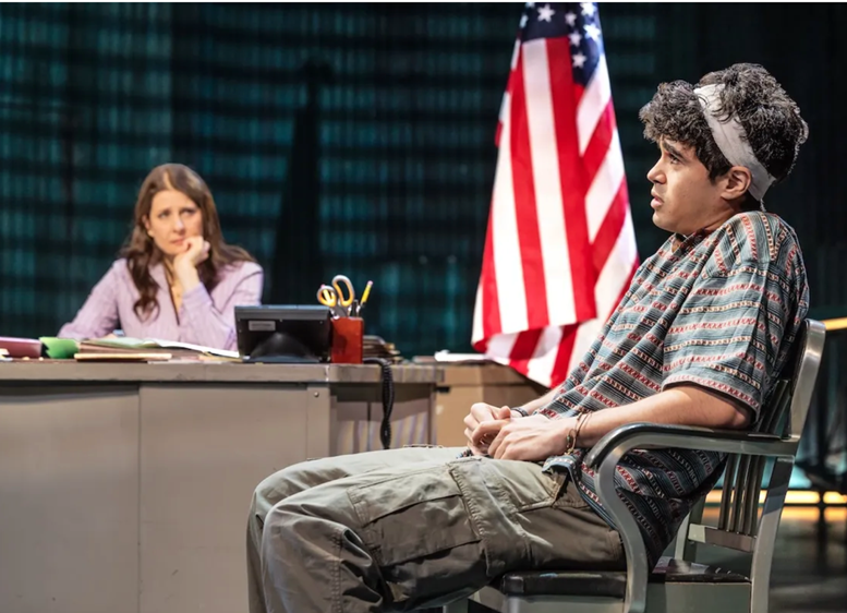 A person sitting in a chair with a person behind him