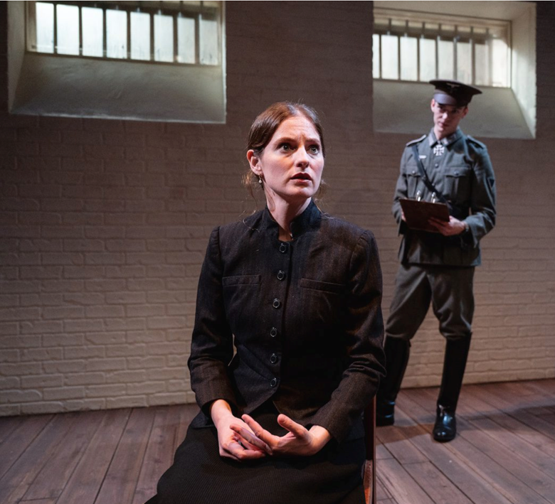 A person sitting on a chair in front of a person in uniform
