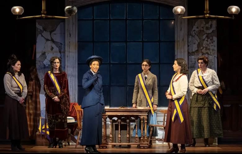 A group of women in clothing on a stage
