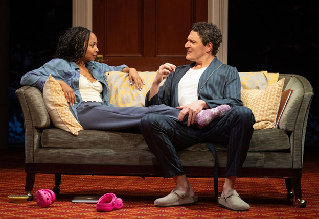 A person and person sitting on a couch