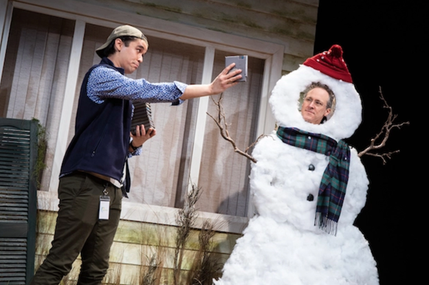 A person taking a picture of a snowman with medium confidence
