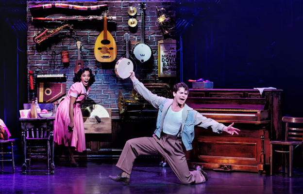 A person and person dancing on a stage with medium confidence